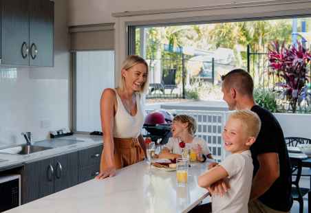 Family enjoying at meal in a Poolside Penthouse