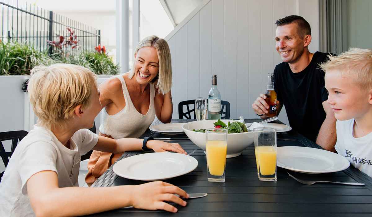 Family enjoying a meal in the Poolside Penthouse Alfresco area
