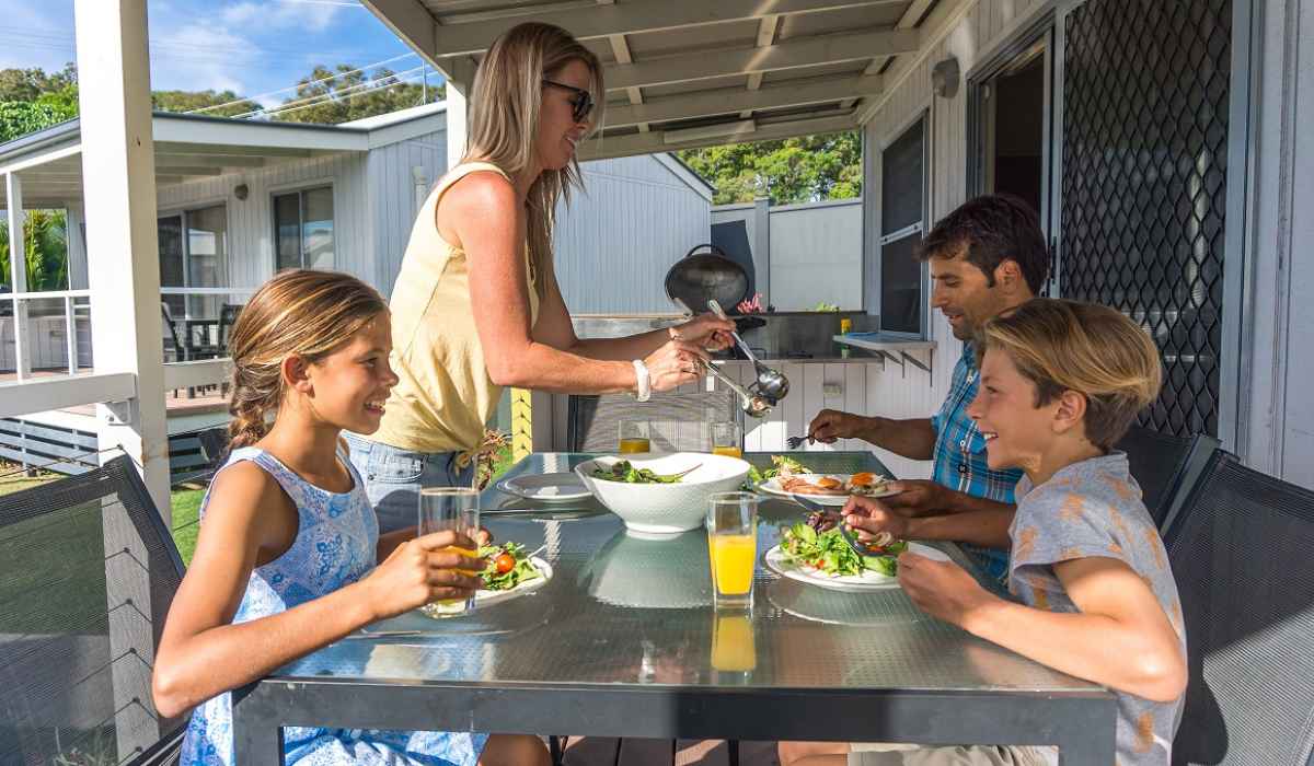 Family enjoying a meal in Alfresco dining with personal BBQ in Deluxe Tropical Villa