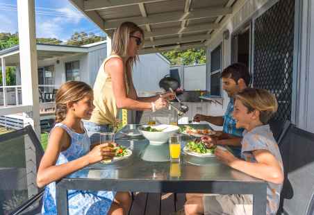 Family enjoying a meal in Alfresco dining with personal BBQ in Deluxe Tropical Villa